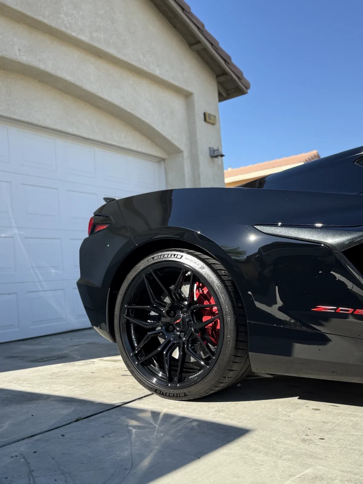 Detailed rear wheel and glossy bodywork of a Chevrolet Corvette Z06