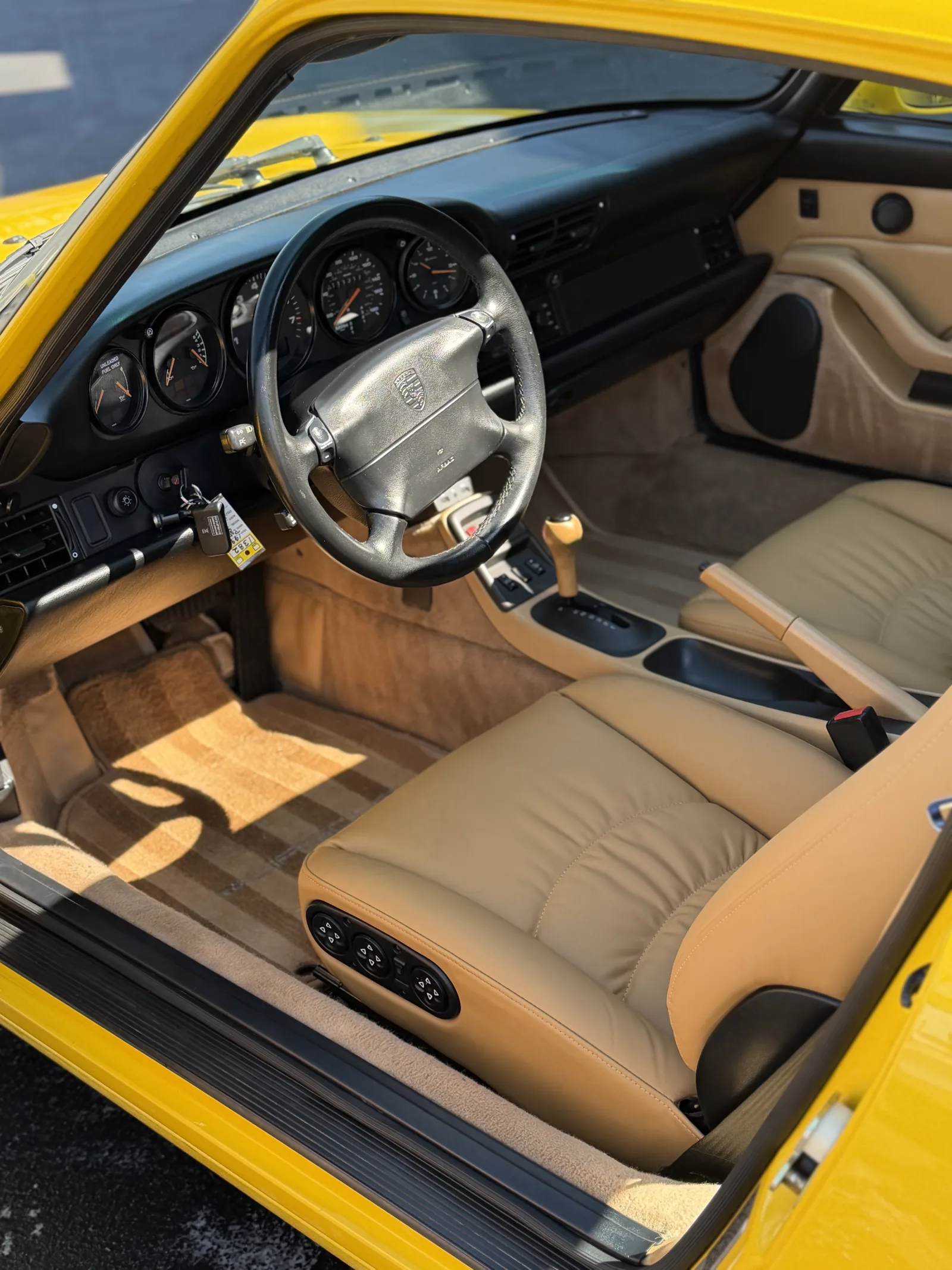 Finished leather seats and cockpit of a yellow Porsche 911