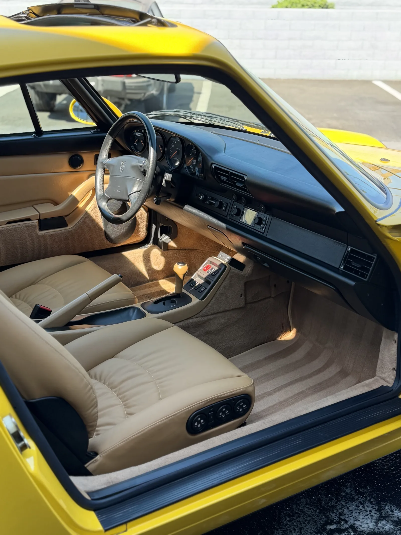 Detailed front cabin and carpeting of a yellow Porsche 911